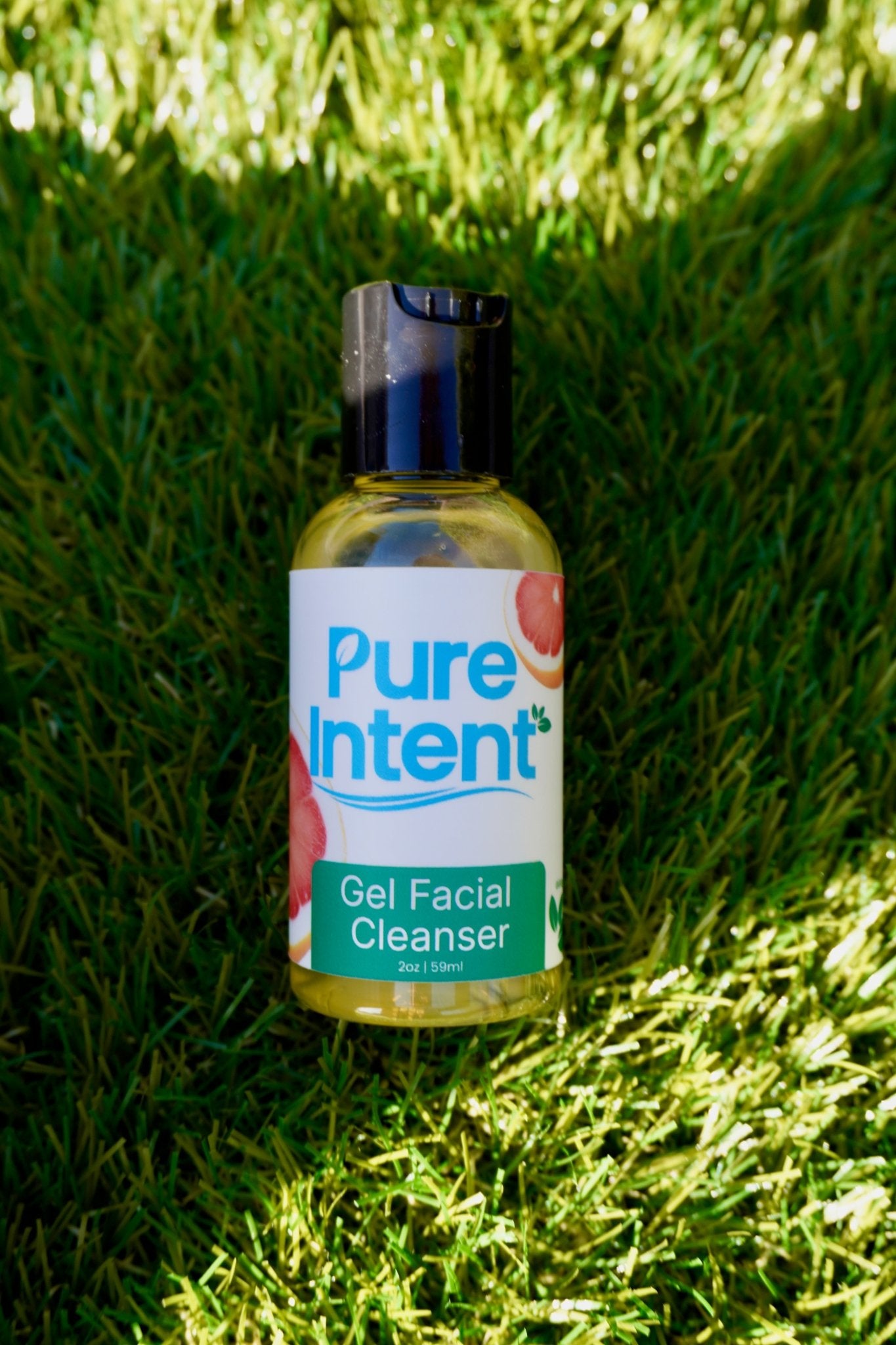 Bottle of Pure Intent Gel Facial Cleanser on grass