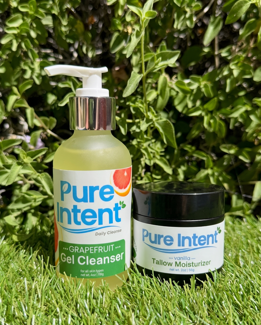Two Pure Intent skincare products on grass with greenery in the background
