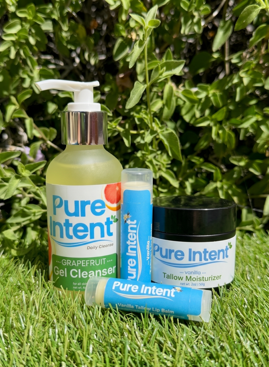 Pure Intent skincare products on grass with greenery in the background